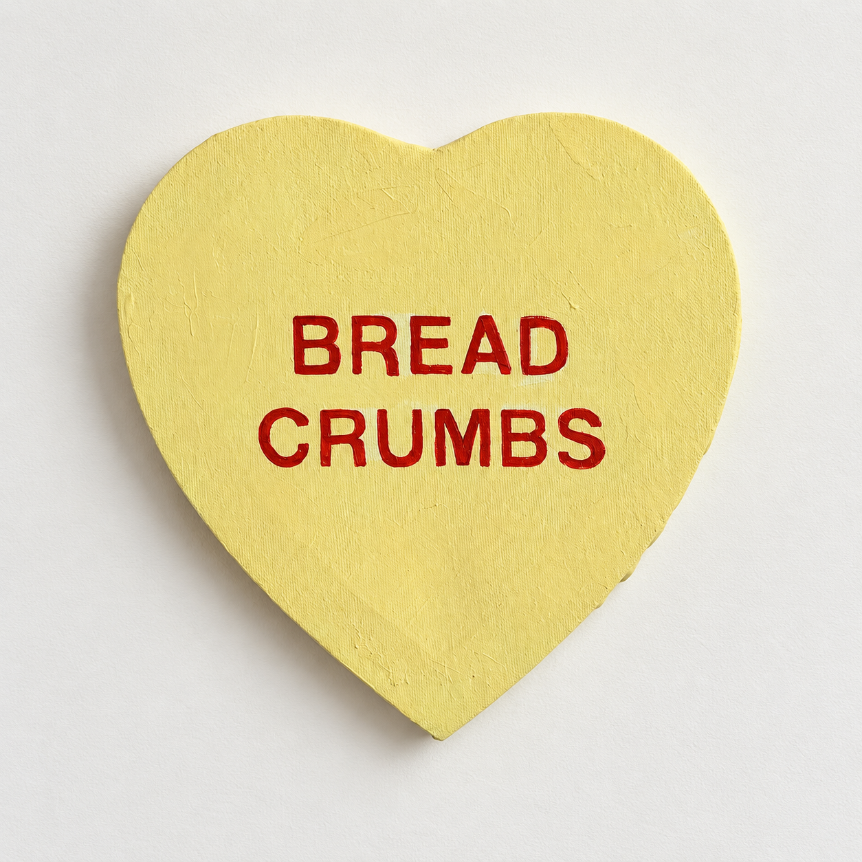 A yellow heart-shaped artwork reading Bread Crumbs